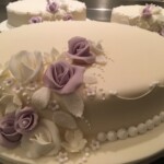 Lemon and Vanilla buttercream, Apricot Jam and rum syrup, decorated in Ivory, white and Lilac.