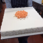 Ivory Celebration Cake with hand-made peach roses.
