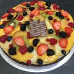 Pastry case lined with chocolate, light grand marnier pastry cream, topped with glazed fruits or strawberries